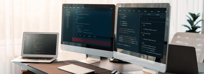 Software development interface display coding script on monitor. Empty tech developer company office with computer screen showing developing software code or website design. Trailblazing