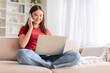 © Prostock-studio - Remote Business. Asian Woman Talking On Phone And Using Laptop At Home