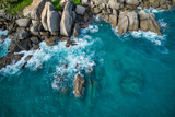 Fototapeta  - Bird eye drone shot of north east point beach, granite rocks, turquoise water, waves crashing, grenery, Mahe Seychelles 9