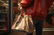 © Fotograf - A woman is depicted wearing a red jacket and carrying a brown bag. This image can be used to represent fashion, shopping, or daily life activities