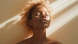 © MakeStories.com - Natural beauty skincare portrait of glowing African-American woman with light hair and sunshine rays upon her