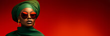 Portrait Of A Black Woman With Green Turban And Sunglasses In Front Of A Red Background With Copy Space