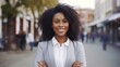© Hixel - Young happy pretty smiling professional business black woman, happy confident positive female entrepreneur standing outdoor on street arms crossed, looking at camera generative ai