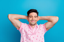 Photo Of Positive Young Person Closed Eyes Arms Behind Head Take Nap Isolated On Blue Color Background