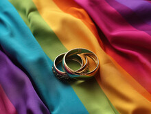 Diverse Wedding Rings With Rainbow Flag Background
