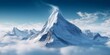 Majestic snowy mountain peak towering above the clouds, its pristine white slopes contrasting against the deep blue sky. Generated by AI.