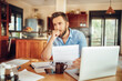 © Geber86 - Man deeply contemplating a document in his home office