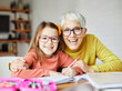© Lumos sp - grandchild grandmother family granddaughter child teacher homework creativity home woman book notebook grandma education classroom grandparent parent daughter girl kid teaching
