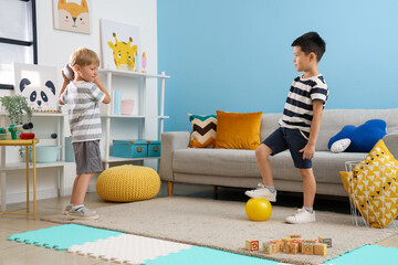 Canvas Print - Cute little boys playing with balls at home