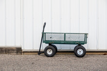 Small Metal Gardening Cart In Font Of The Farm House.