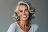 Fototapeta  - Beautiful gorgeous 50s mid age beautiful elderly senior model woman with grey hair laughing and smiling. Mature old lady close up portrait. Healthy face skin care beauty, skincare cosmetics, dental.