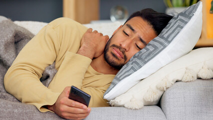 Canvas Print - Man, phone and blanket on sofa in home living room, tired and web chat with email notification. Guy, smartphone and sick with research for health, medicine and watch video on social media in house