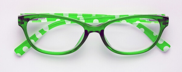 Green reading glasses isolated on a white background