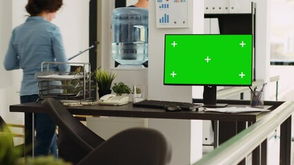 Poster - empty workstation with greenscreen running on computer, open floor plan coworking space presenting i