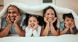 © C. Daniels/peopleimages.com - Happy, love and portrait of a family in bed with a blanket relaxing, resting and bonding at home. Happiness, smile and young children laying with their mother and father in the bedroom of their house