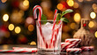A festive holiday cocktail with a candy cane garnish and a colorful straw.