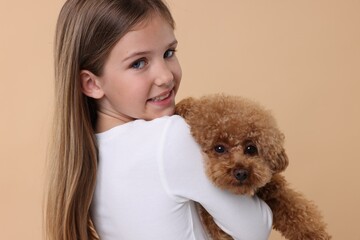 Wall Mural - Little child with cute puppy on beige background. Lovely pet