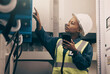 Black woman, engineering technician and phone in control room to connect system, mechanic industry or machine maintenance. Female electrician, mobile technology or check power at electrical generator