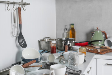 Wall Mural - Many dirty utensils, cookware and dishware on countertop in messy kitchen