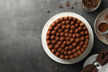 Delicious tiramisu cake with cocoa powder on grey table, flat lay. Space for text