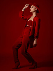 art, fashion and a model woman on a red studio background for elegant or trendy style. aesthetic, be
