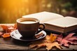 A warm mug of spiced chai tea nestled among fall leaves and a captivating novel on an old wooden table