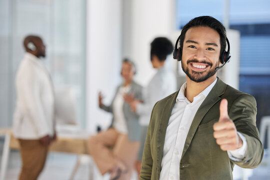 Asian man, call center and portrait smile with thumbs up for good job, thank you or agree at the office. Happy male consultant or agent showing thumb emoji or sign for success, winning or yes at work
