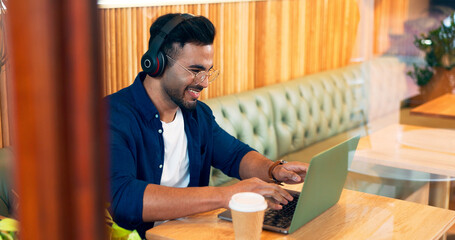 Poster - Happy man in cafe, typing on laptop and music for remote work, reading email and writing. Computer, freelancer and editor in coffee shop, headphones and listening to radio, podcast or audio at table