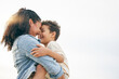 © Charlize D/peopleimages.com - Beach, sunset and love of mom for child, boy or son together outdoor in nature on holiday, vacation or heads touching with a smile. Mother, woman and kid with happiness, care and mockup with sky