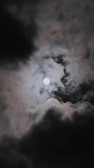 Wall Mural - full moon moving between clouds. vertical video