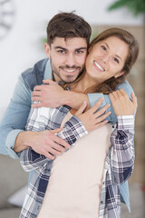 Wall Mural - happy young couple hugging indoors