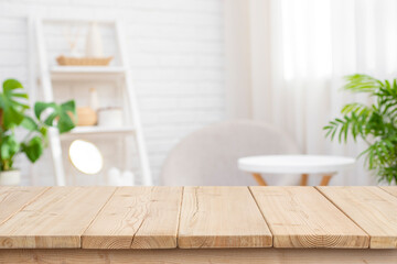 Wall Mural - blank wooden table for product display with blurred spa salon waiting area as background