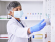 © D Theron/peopleimages.com - Pharmacy, medicine and woman in face mask for healthcare, medical inventory and pharmaceutical service. Shelf, product and reading label of pharmacist or senior person for virus, bacteria or covid 19