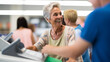 © kalafoto - A happy supermarket cashier at work