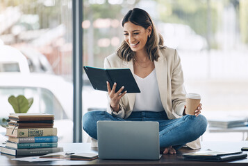 Aufkleber - Business woman, laptop or reading notebook while sitting on desk in marketing office, advertising company or creative startup. Smile, happy or relax worker with books, technology or innovation vision