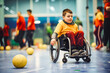 Disabled young boy player playing on wheelchair and having fun, game with ball, special needs child enjoying sport
