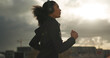 © HockleyMedia/peopleimages.com - Exercise, music and a sports woman running in the city for health or cardio preparation of a marathon. Fitness, wellness or training and a young runner or athlete listening to audio with headphones