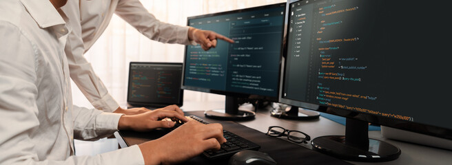 Software development team working together in office, coding script display on computer monitor. Programmer and software engineer working in tech developer company. Trailblazing