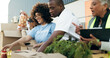 © N Felix/peopleimages.com - Group of people, charity and food donation on table for community event with care, boxes and help. Volunteer team, men and women at ngo checking grocery package for distribution at non profit project