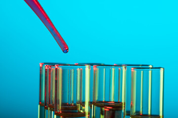 Poster - Close up of laboratory test tubes and pipette with copy space on blue background