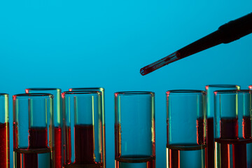 Poster - Close up of laboratory test tubes and pipette with copy space on blue background