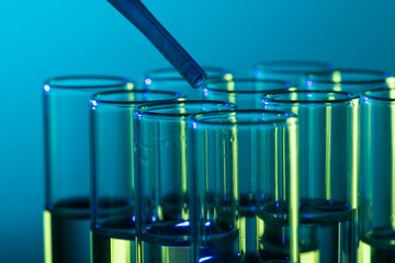 Poster - Close up of laboratory test tubes and pipette with copy space on blue background