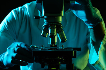 Poster - Scientist using microscope and copy space on black background
