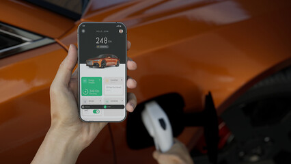 CU Caucasian man using EV application on his phone to check charging status 