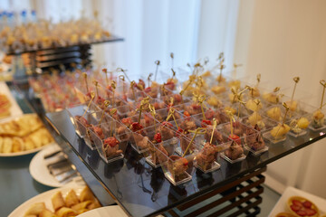 Wall Mural - light snacks for the holiday, catering. Various light snacks. Catering plate. Assortment of sandwiches on the buffet table. meat, fish, vegetable canapes.