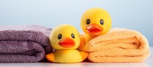 Three Vibrant Towels Featuring A Plush Yellow Duck Are Set Apart On A White Background