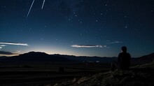 A Man Watches The Perseid Meteor Shower On The Pamir Plateau
