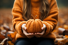 Halloween Autumn Background - Closeup Of Child Holding A Knitted Orange Halloween Pumpkin In The Hands 