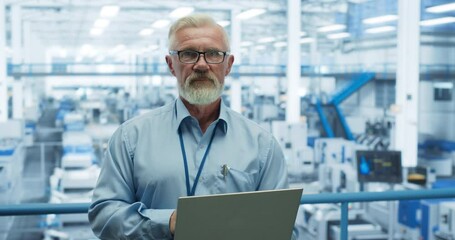 Aufkleber - Portrait of a Handsome Middle Aged Engineer with a Beard and Glasses Using Laptop Computer and Looking at Camera. Male Specialist Working in a Modern Electronics Factory