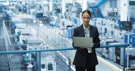 Aufkleber - Portrait of a Beautiful Happy Engineer Using Laptop Computer and Looking Around a Factory Facility with Automated Robotic Arms Producing Modern Electronic Components for Different Industries